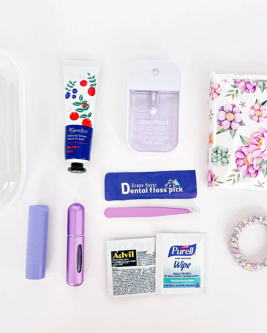 Flat lay of Everyday Essentials Kit with personal care items in purple.