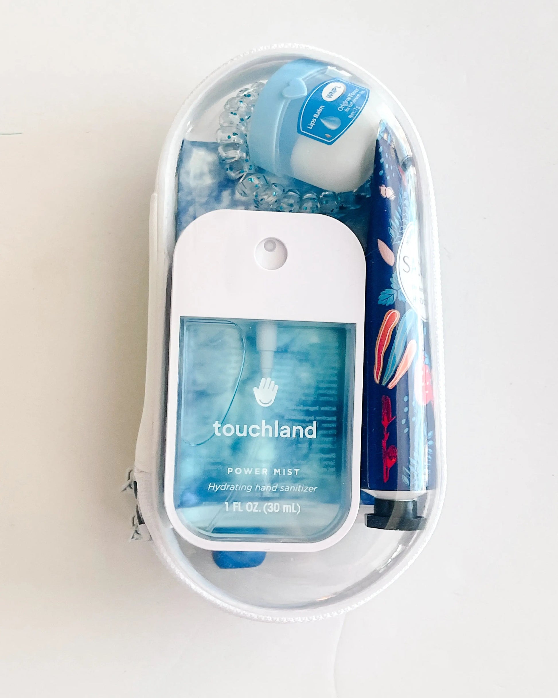 Everyday Essentials Kit filled with travel-size must-haves in blue