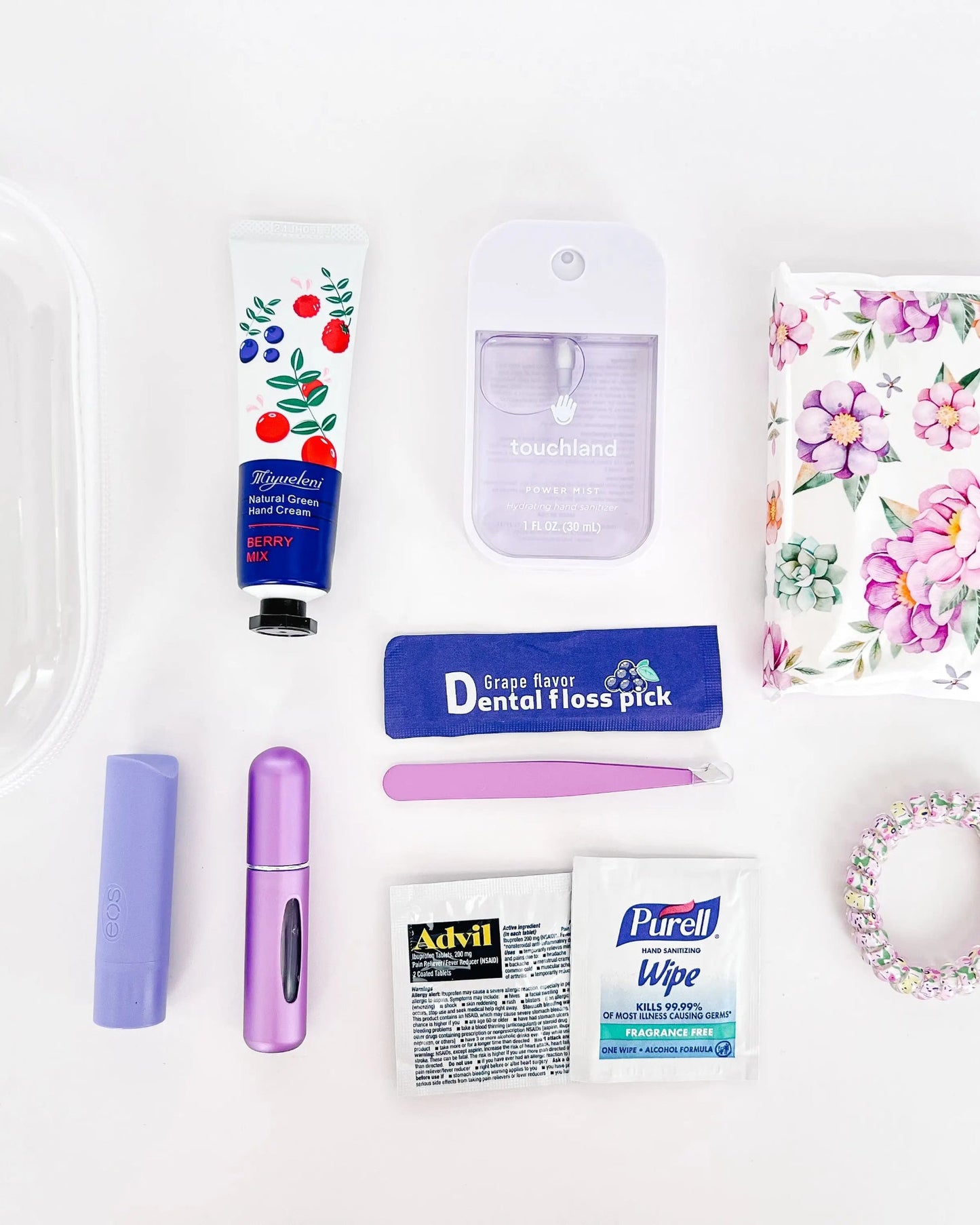 Flat lay of Everyday Essentials Kit with personal care items in purple.