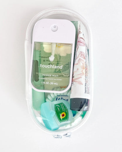 Everyday Essentials Kit filled with travel-size must-haves in green.