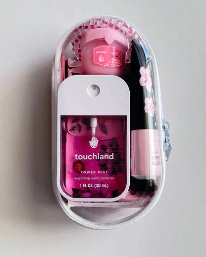 Everyday Essentials Kit filled with travel-size must-haves in pink. 