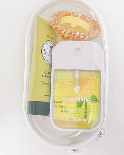 Everyday Essentials Kit filled with travel-size must-haves in yellow.