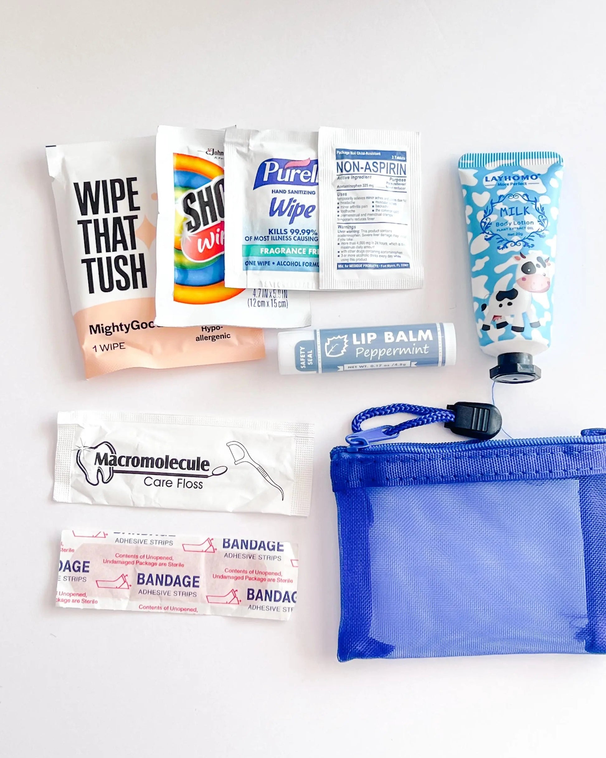 Compact Essential Pocket Kit flat lay with tissue pack and blue mesh pouch