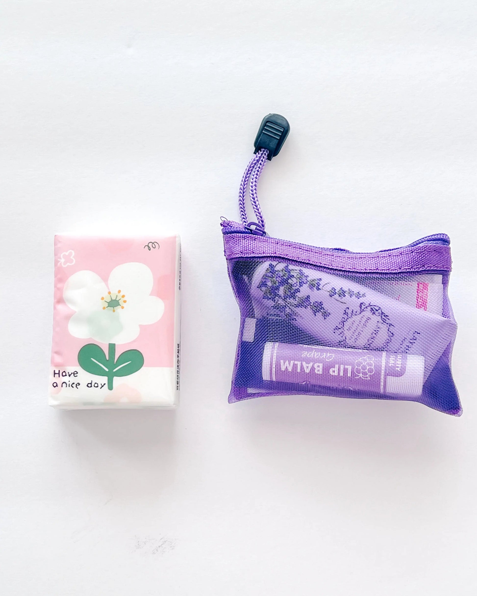 Pocket Essentials Kit My StoreCompact Essential Pocket Kit flat lay with tissue pack and purple mesh pouch