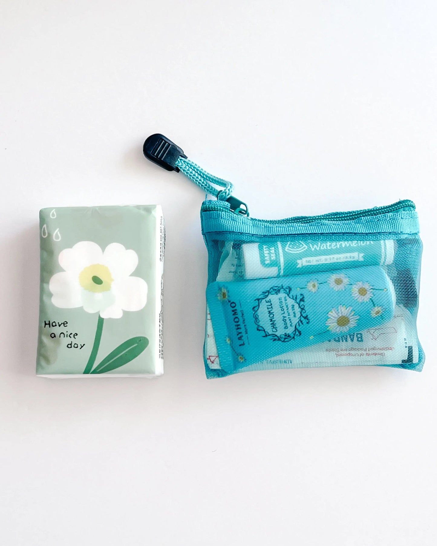 Compact Essential Pocket Kit flat lay with tissue pack and turquoise  mesh pouch