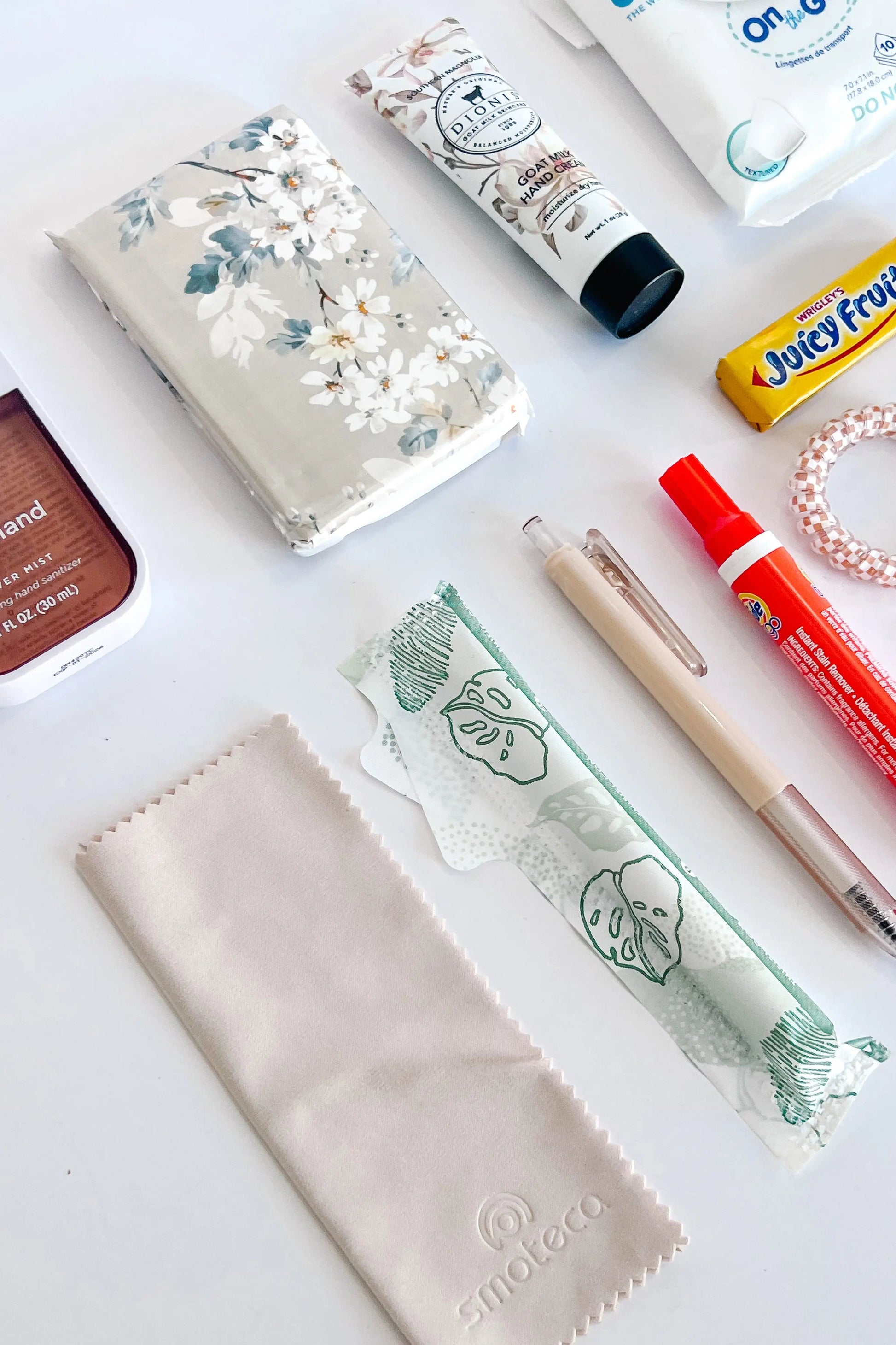 The Purse Pouch close up of tissue, tampons, eyeglass/sunglass cleaner cloth, tide pen, pen, etc. 